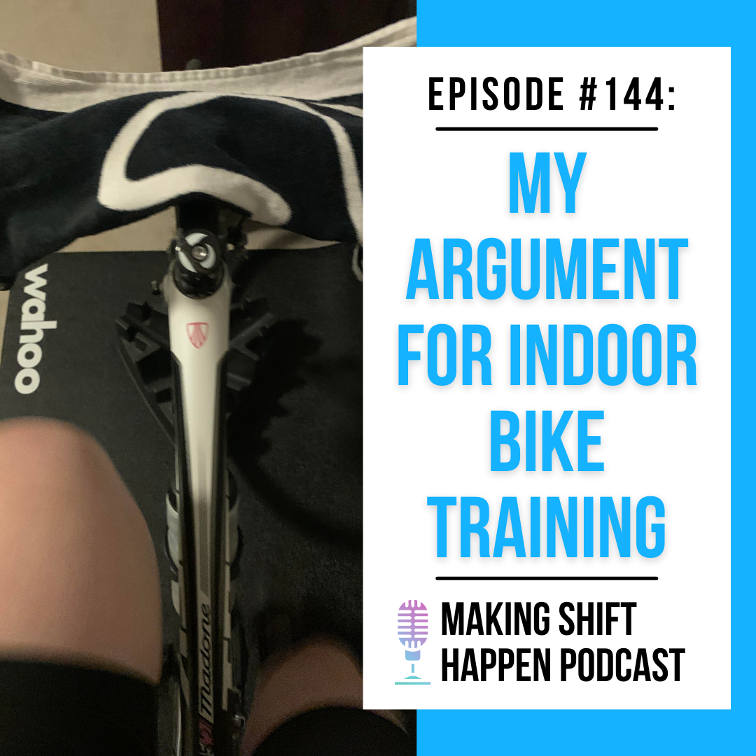 Jen's white legs are pedaling on an indoor bike that's on a Wahoo Kickr trainer, while she is wearing black cycling chamois shorts. A towel is draped across her handlebars. The photo is captured by looking down at her legs from her vantage point on the bike.