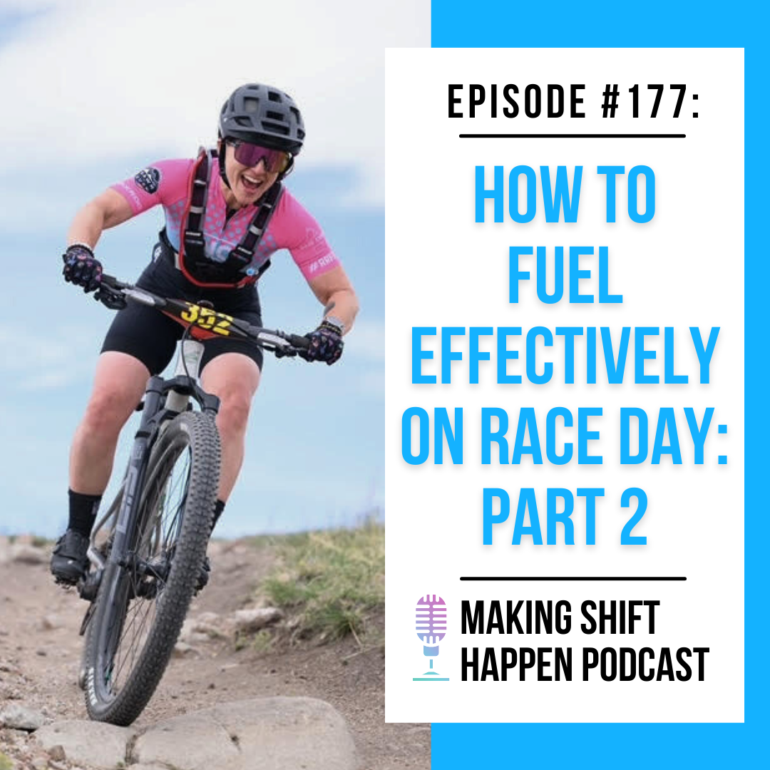 Jen is wearing a blue, pink, and black kit while she's smiling on her mountain bike with a black and orange race number pinned to the front of her bike.